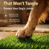 A dog's paw rests on a green, artificial grass mat used for toilet training.