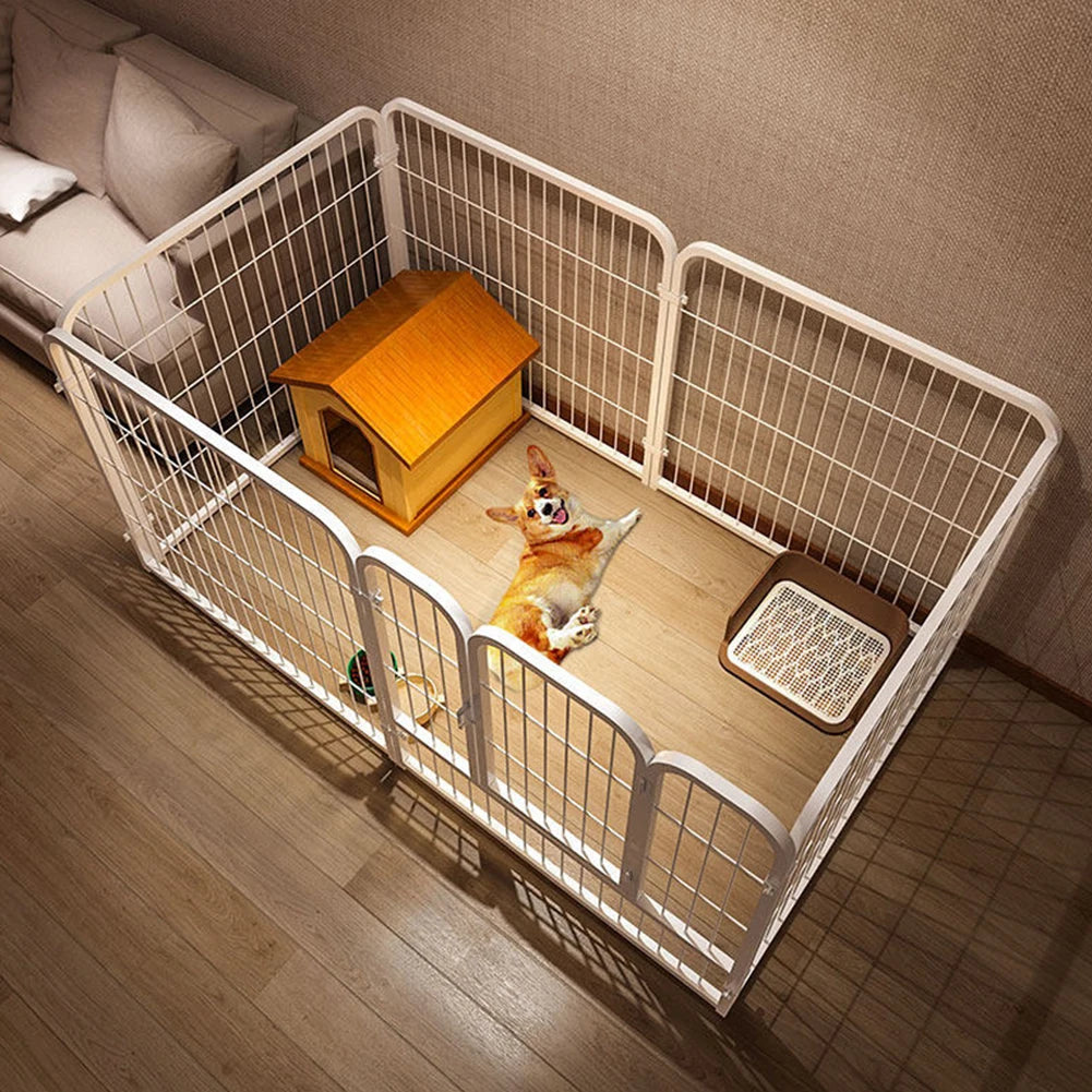 A wooden pet playpen with white vertical bars and a wooden house for a dog is shown on a floor.