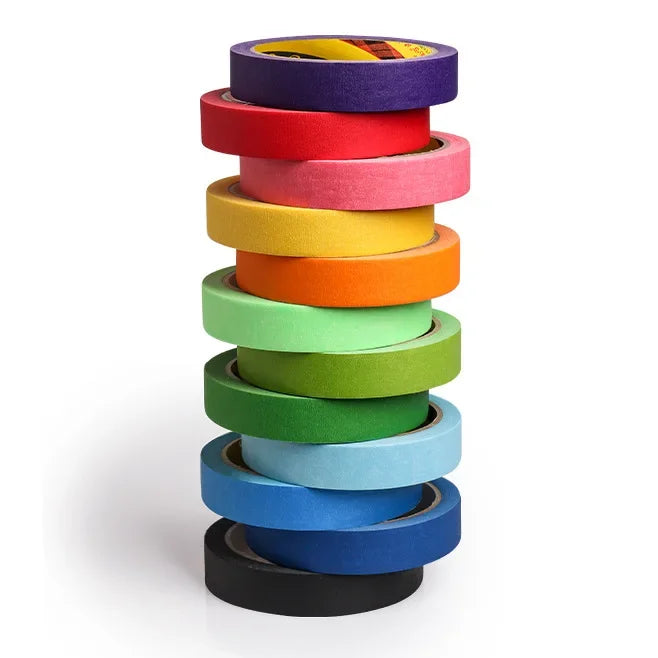 A stack of orange multi-surface masking tape rolls in various shades of orange and yellow.