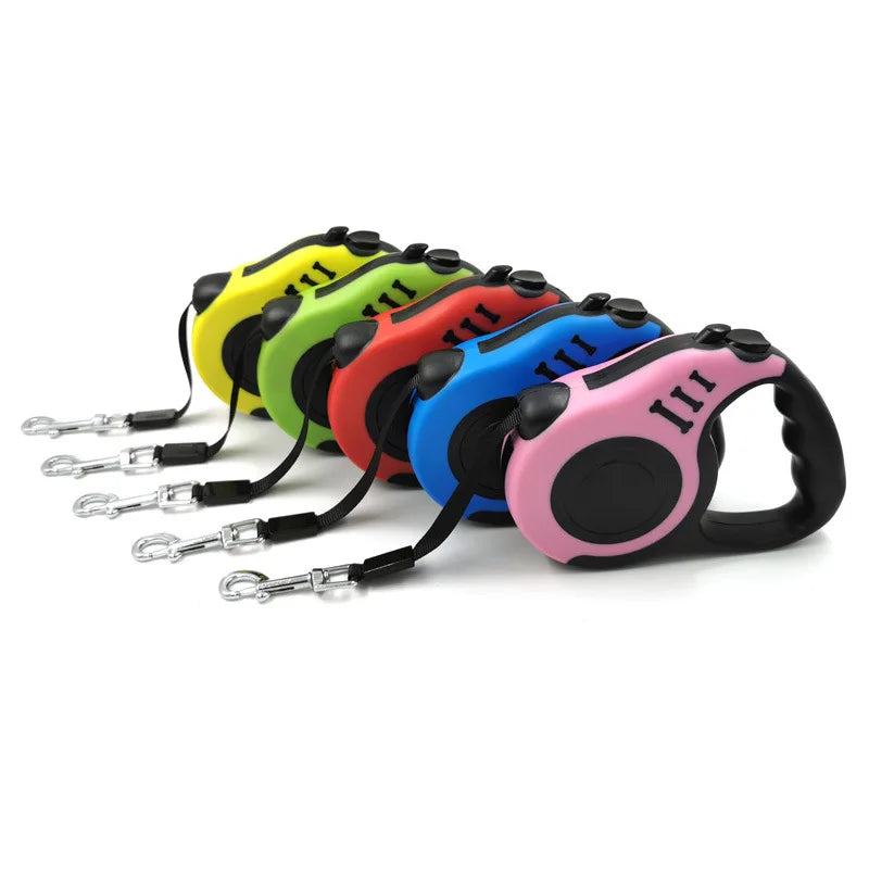 A row of colorful retractable dog leashes with comfortable grips laid out on a white background.