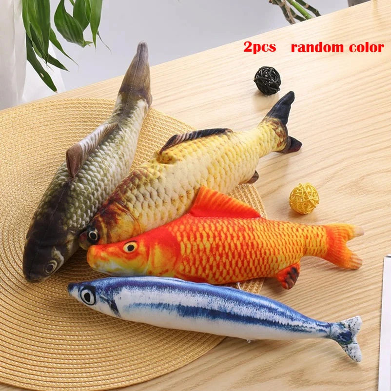 Two plush fish toys in various colors and shapes are displayed on a woven mat.