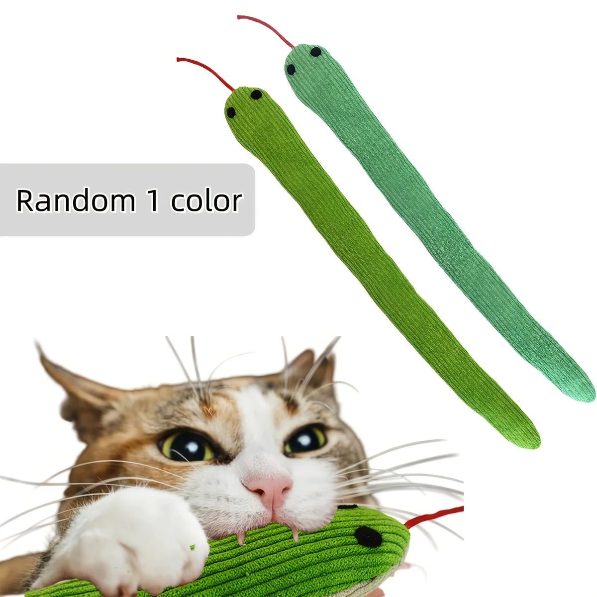 A tabby cat is interacting with a green crinkle toy featuring two red and green strands.
