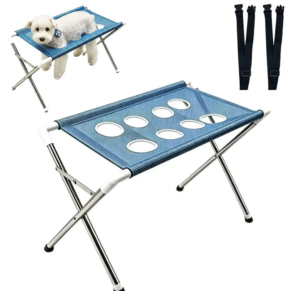 A blue pet grooming stand with a mesh hammock for bathing and nail trimming, featuring a white dog.