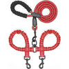 A red dual dog leash with a 360 degree swivel and shock-absorbing bungee attached to a collar.