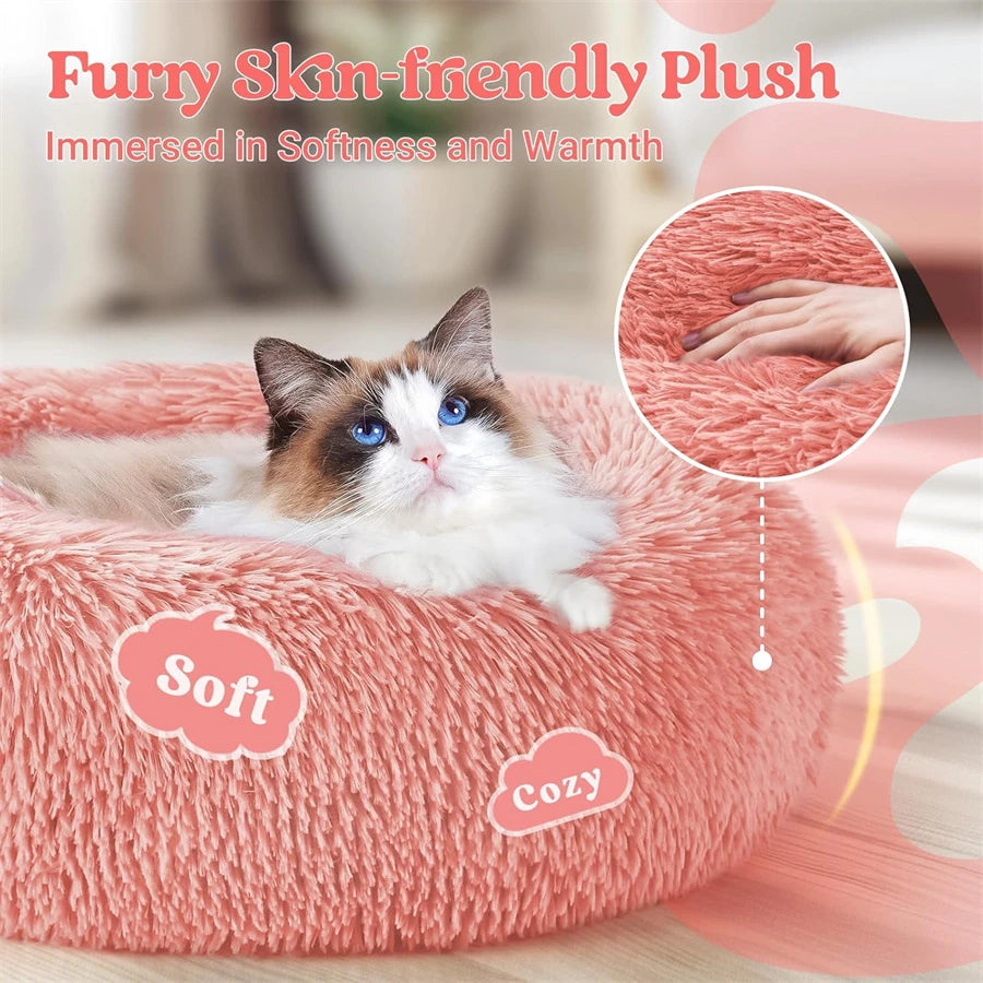 A fluffy pink pet bed with a cat resting on it, emphasizing softness and warmth.