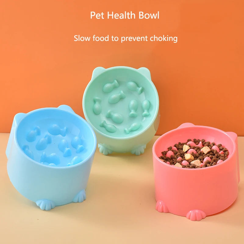 Three pet health bowls in light blue, mint green, and pink are shown against an orange background for slow feeding.