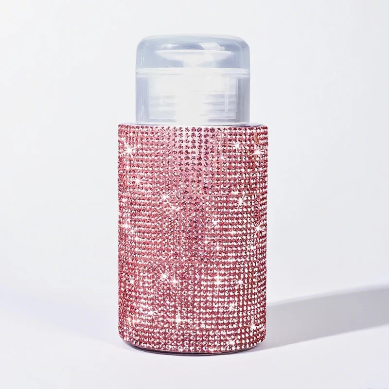 A refillable diamond design pump bottle with a pink glitter texture and a clear cap.