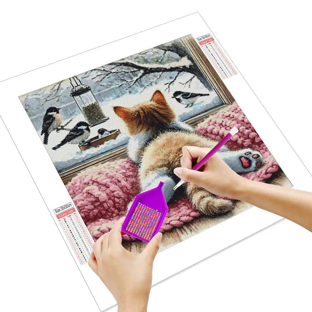 Hands painting a 5D diamond painting kit featuring a cat and birds mosaic art for wall decor