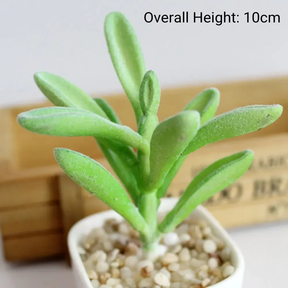 A small, green flocked artificial succulent plant in a white pot, showing its upright growth.