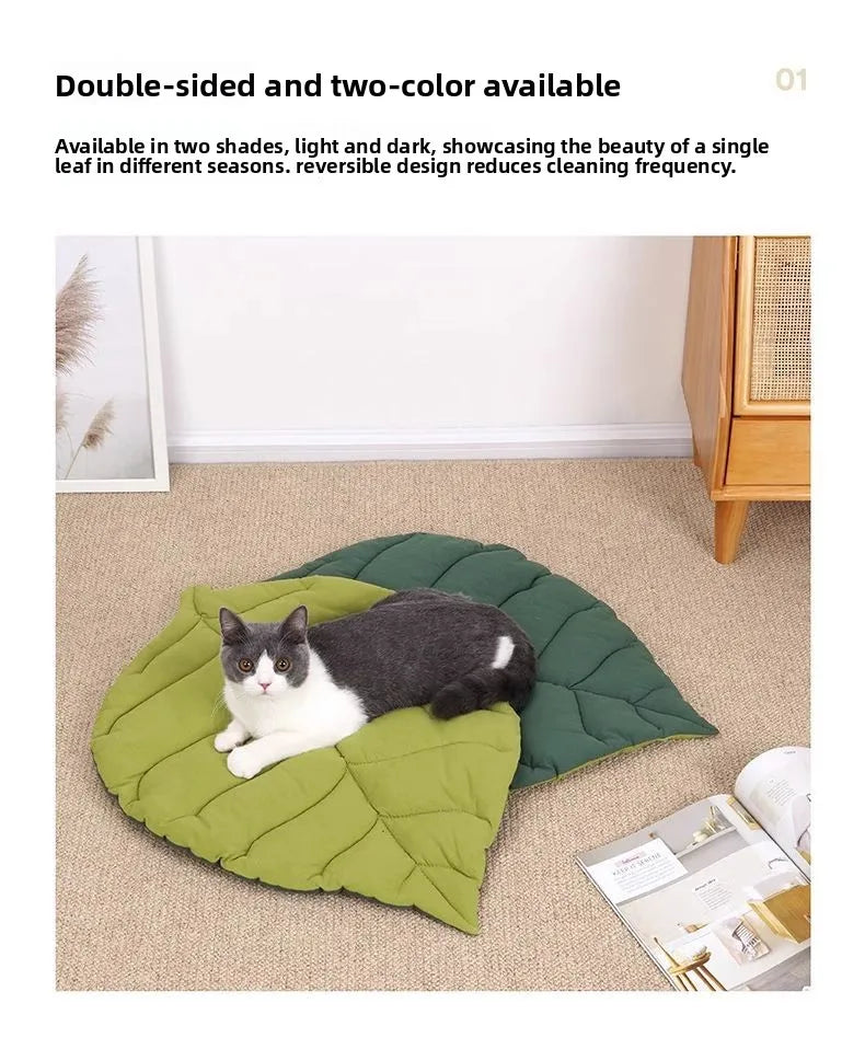 A green quilted pet cushion with a black and white leaf print is shown on a beige carpet.