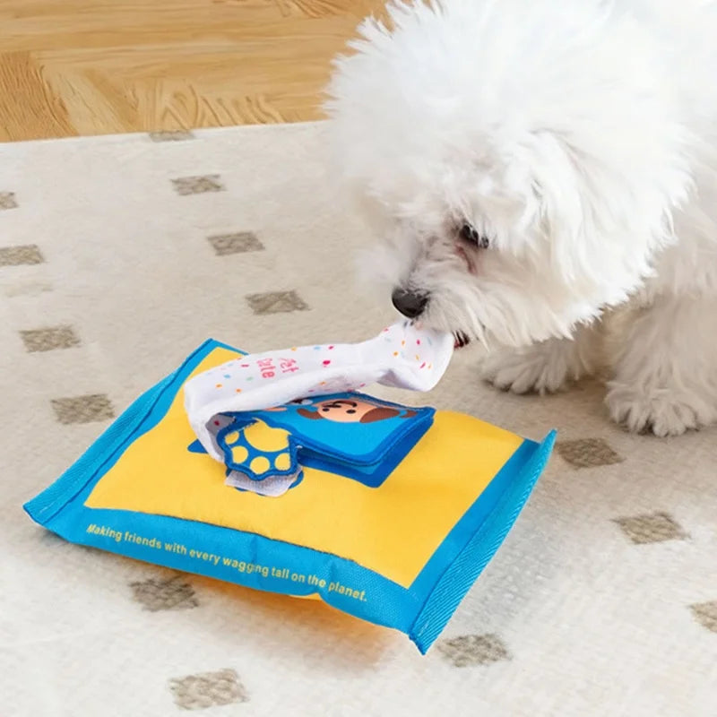 A fluffy white dog is interacting with a blue and yellow denim puzzle toy for pets.