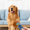 A hand is holding a blue ultrasonic dog bark deterrent trainer near a golden retriever.