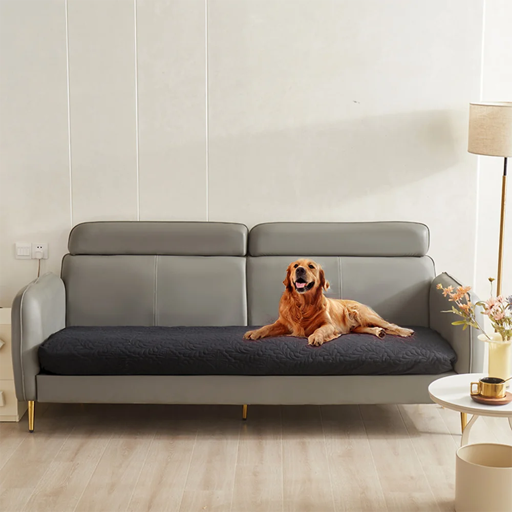A gray waterproof pet bed cover is placed on a sofa, protecting the upholstery and mattress for dogs or cats.