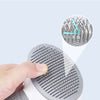 A hand holds a gray self-cleaning pet grooming brush with a 60 degree adjustable needle body, demonstrating its use.