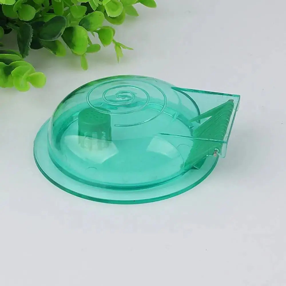 A transparent green silicone snail catcher trap used for safely catching snails in aquariums.