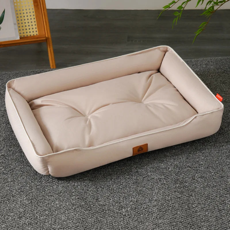 A beige luxurious corduroy pet sofa bed for dogs and cats resting on a gray carpet.