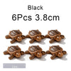Six black turtle floating ornaments, each measuring 3.8cm.