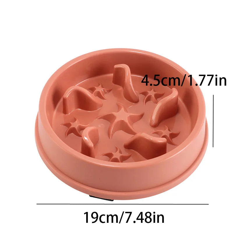 A pink anti-slip slow feeder bowl with star-shaped ridges for small dogs and cats.