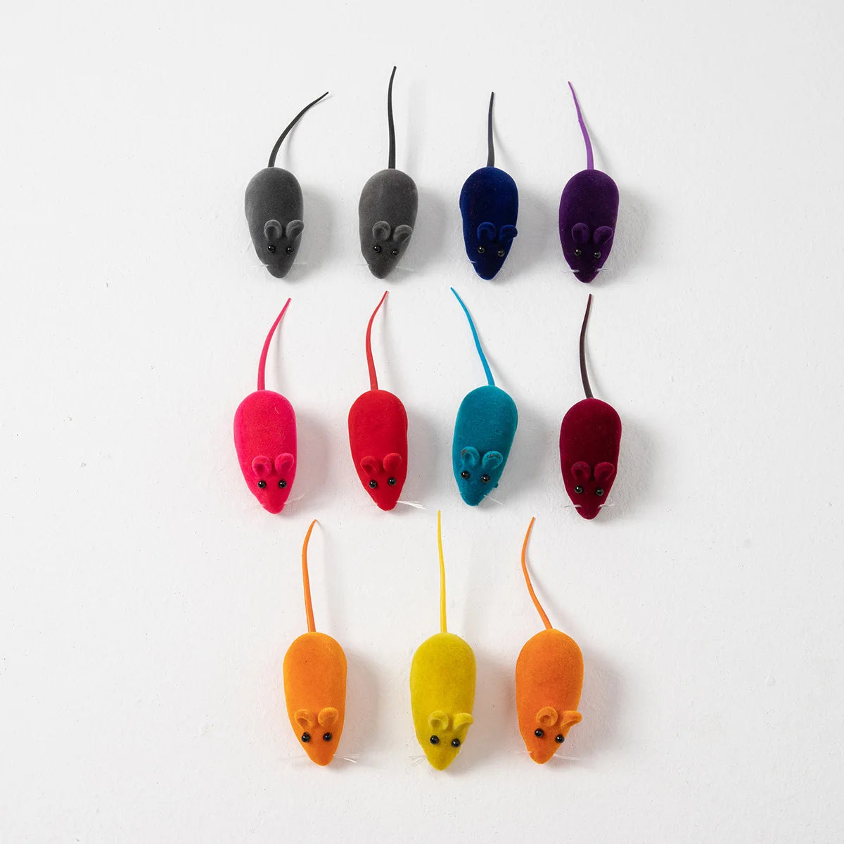 A collection of nine interactive squeaking mouse toys for cats in various shades of gray, purple, and red.