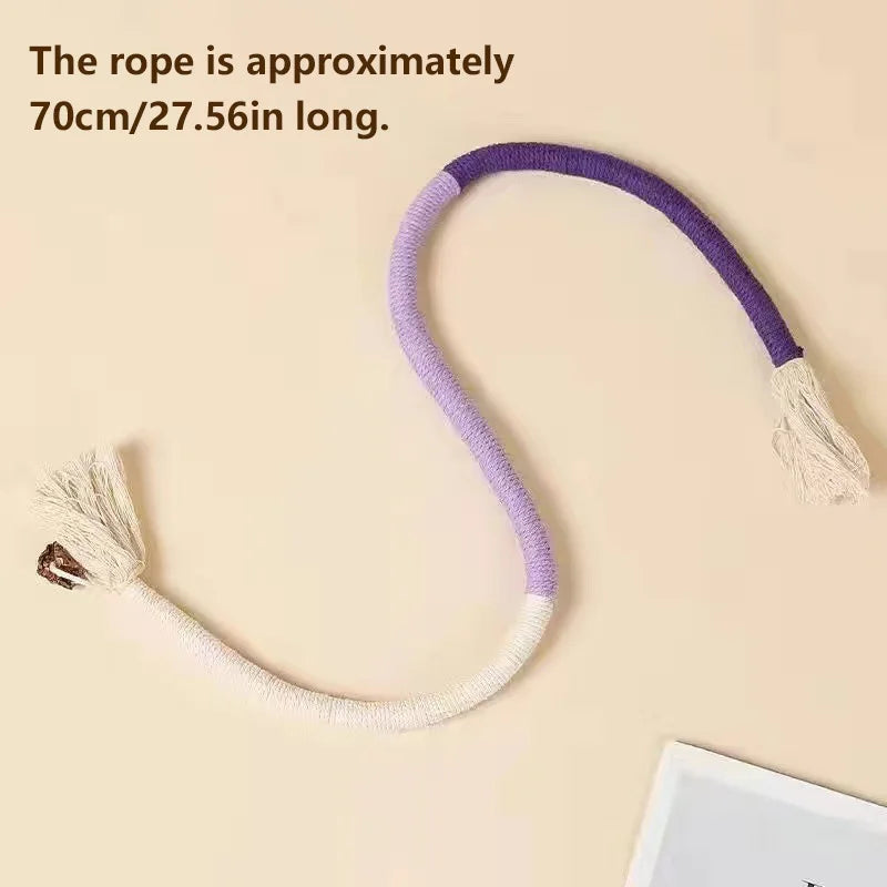 A purple and white organic cotton cat chew rope with a fluffy tassel end.