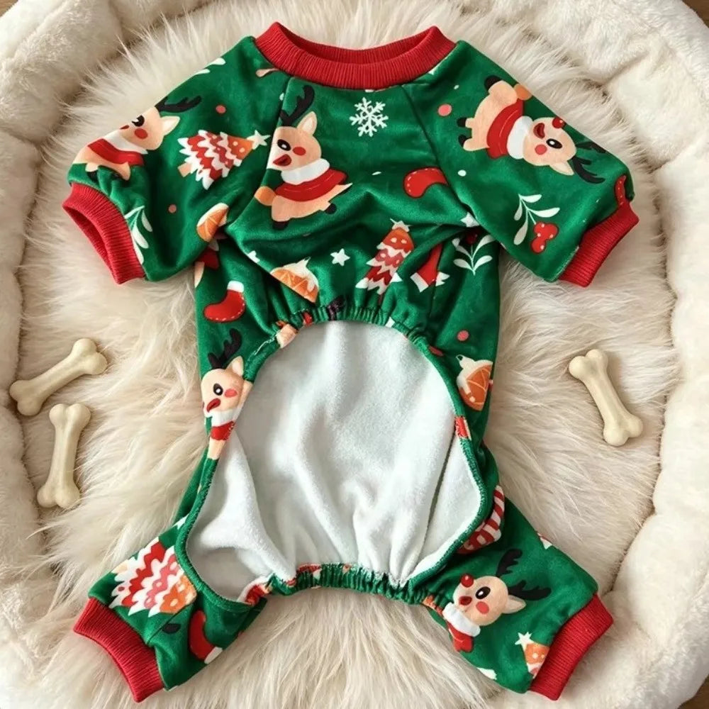 Green fleece dog pajamas with a white and red Santa Claus print lying on a white fluffy rug