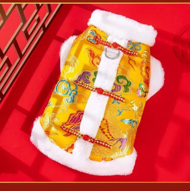 A yellow Chinese style tang suit dog coat with red embroidery and white fur trim.