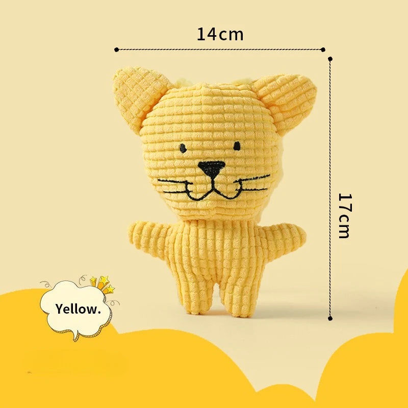 A yellow, crocheted plush toy resembling a lion or dog with large ears and a stitched nose.
