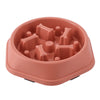 A terracotta-colored slow feeder dog bowl with a maze design for small and medium dogs.