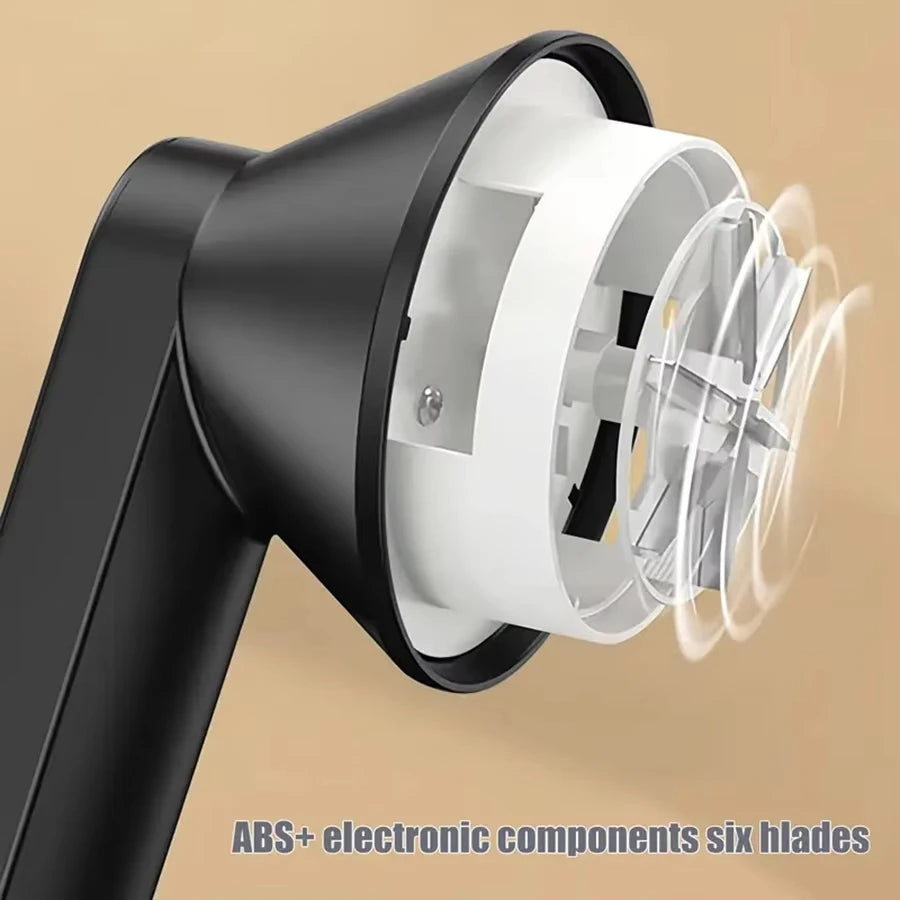 A black portable electric lint and fabric shaver with a white head is shown in a close-up view.