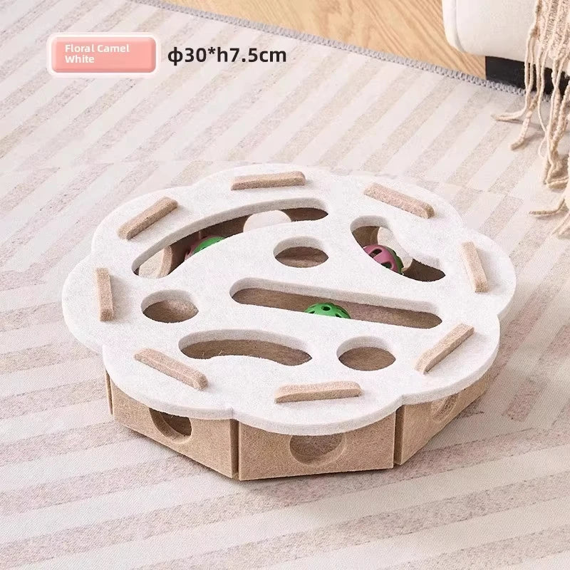 A white felt puzzle toy for cats with various holes and wooden sticks.