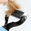 A hand is using a stainless steel pet hair removal comb brush to groom brown pet fur.