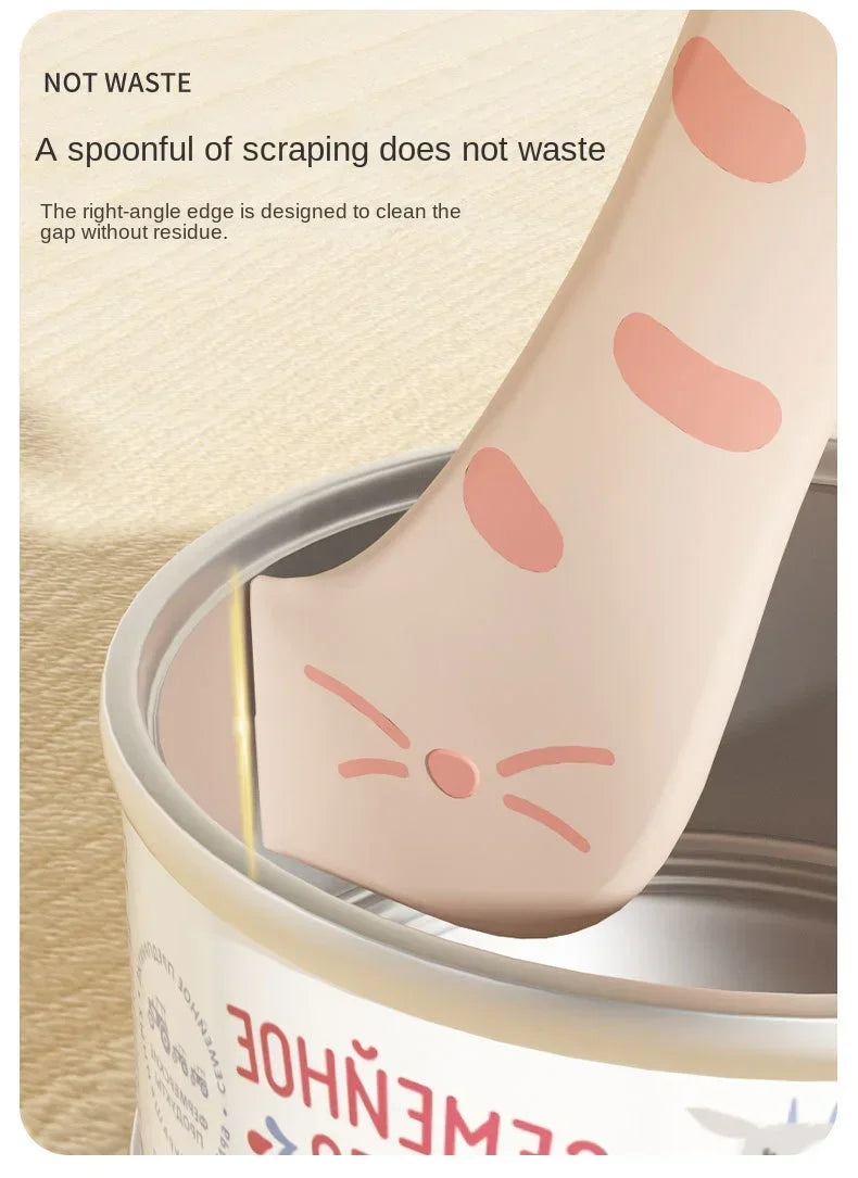 A pink silicone spoon designed for scraping, shown inside a can, demonstrating its use without waste.