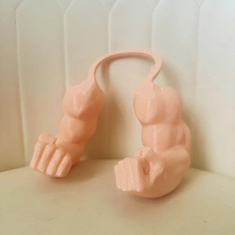 A pink 3D printed cat muscle arm accessory shaped like a hand and forearm.