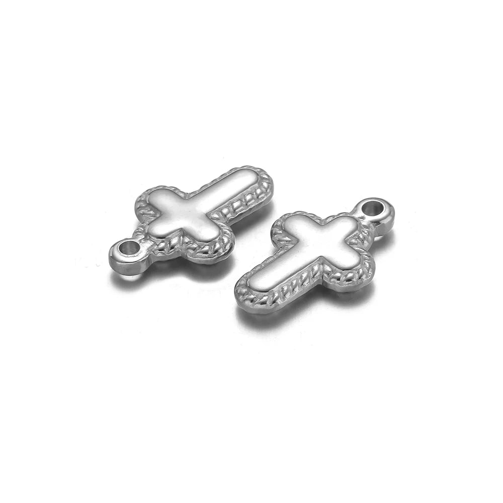 A pair of silver vintage cross charms used for DIY jewelry making.