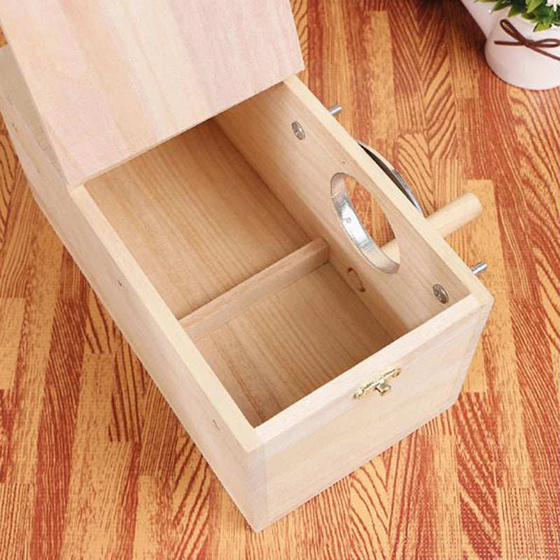 A light wood bird nest box with an open lid showing a small interior compartment and a silver wire.