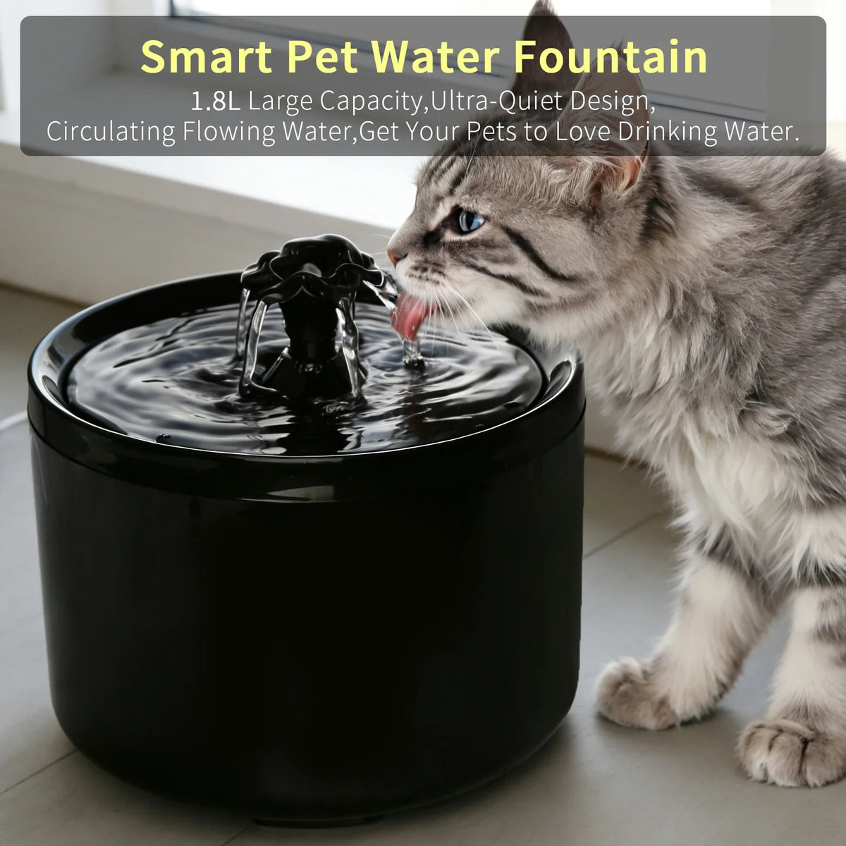 A tabby cat is drinking water from a black pet water fountain bowl.