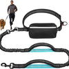 A black retractable bungee leash and harness system for dogs, shown with a person and a dog.