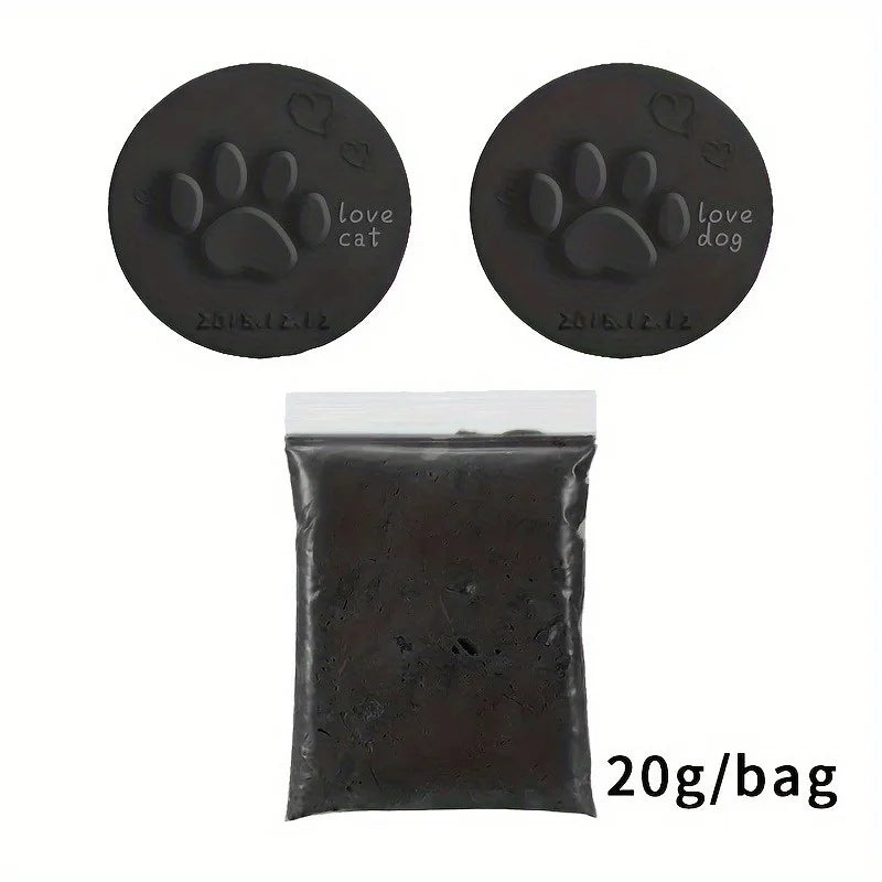 A package of dark brown clay for making paw print keepsakes, with two finished clay discs showing paw prints and 'love cat' a