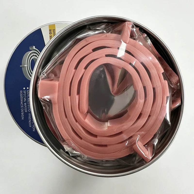A roll of pink calming pheromone collar for cats and dogs is displayed in a metal tin.