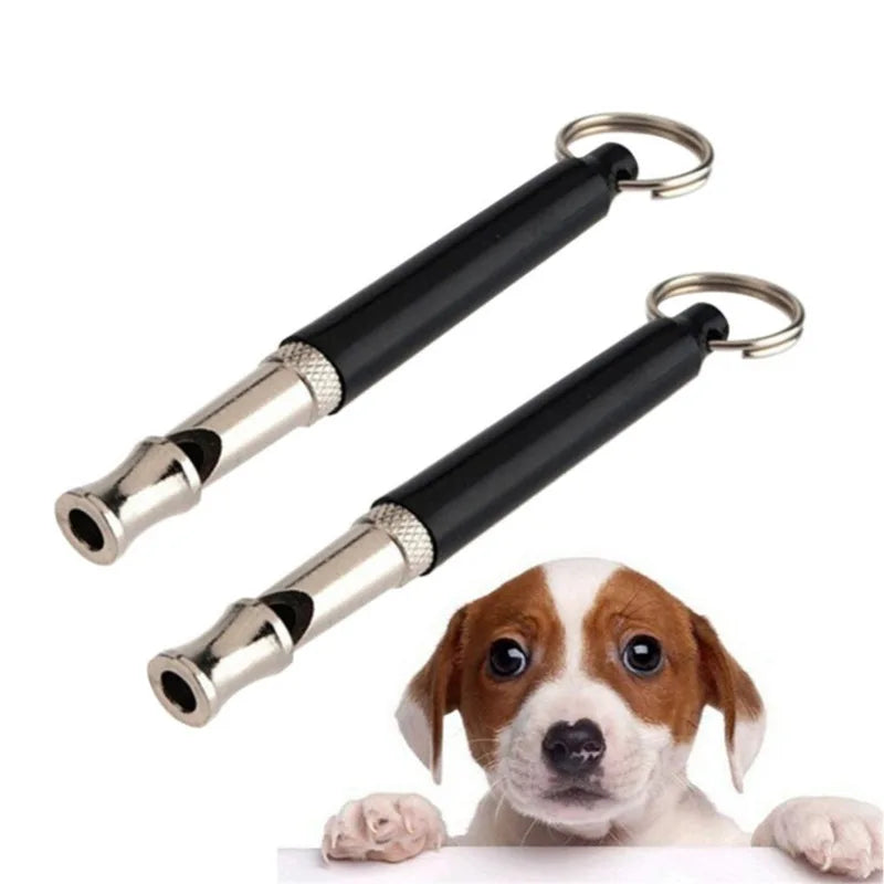 A black and silver adjustable ultrasonic dog training whistle with a metal clip.