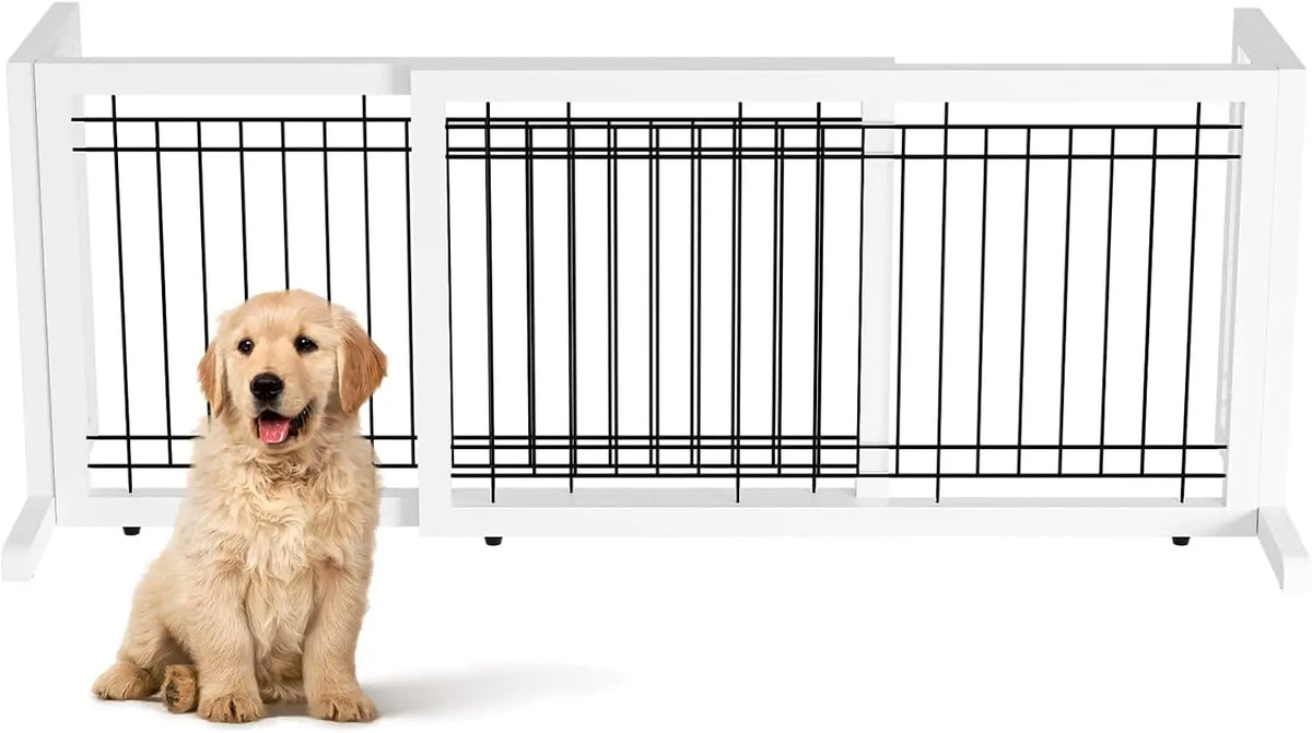 A white adjustable wooden pet gate with black bars, featuring a golden-colored dog sitting in front of it.