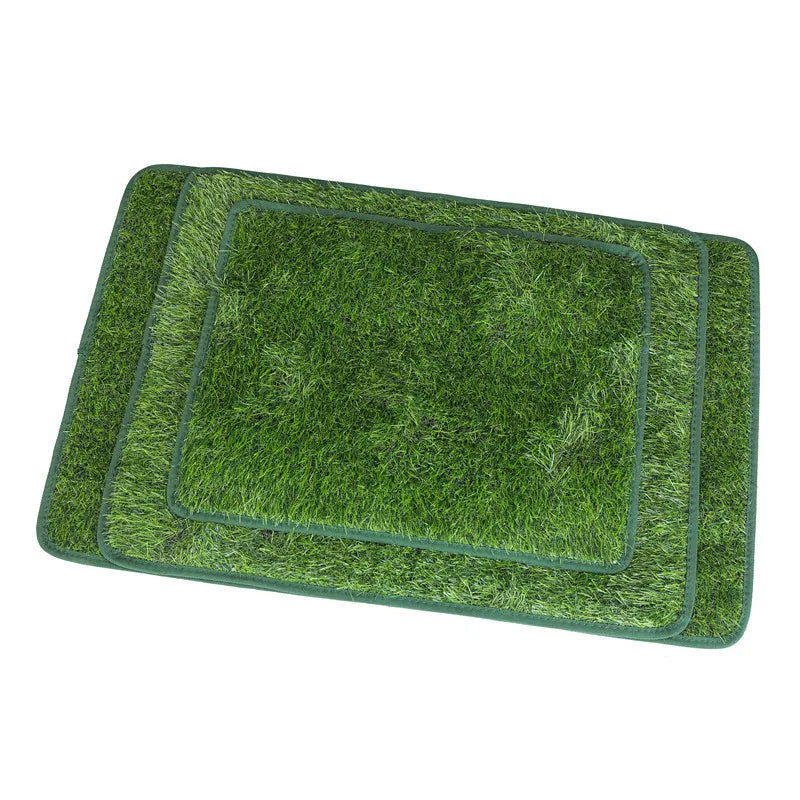 A rectangular green artificial grass dog potty mat with a square insert and a surrounding border.