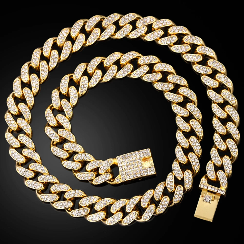 A gold-toned diamond Cuban link necklace set displayed on a black background.