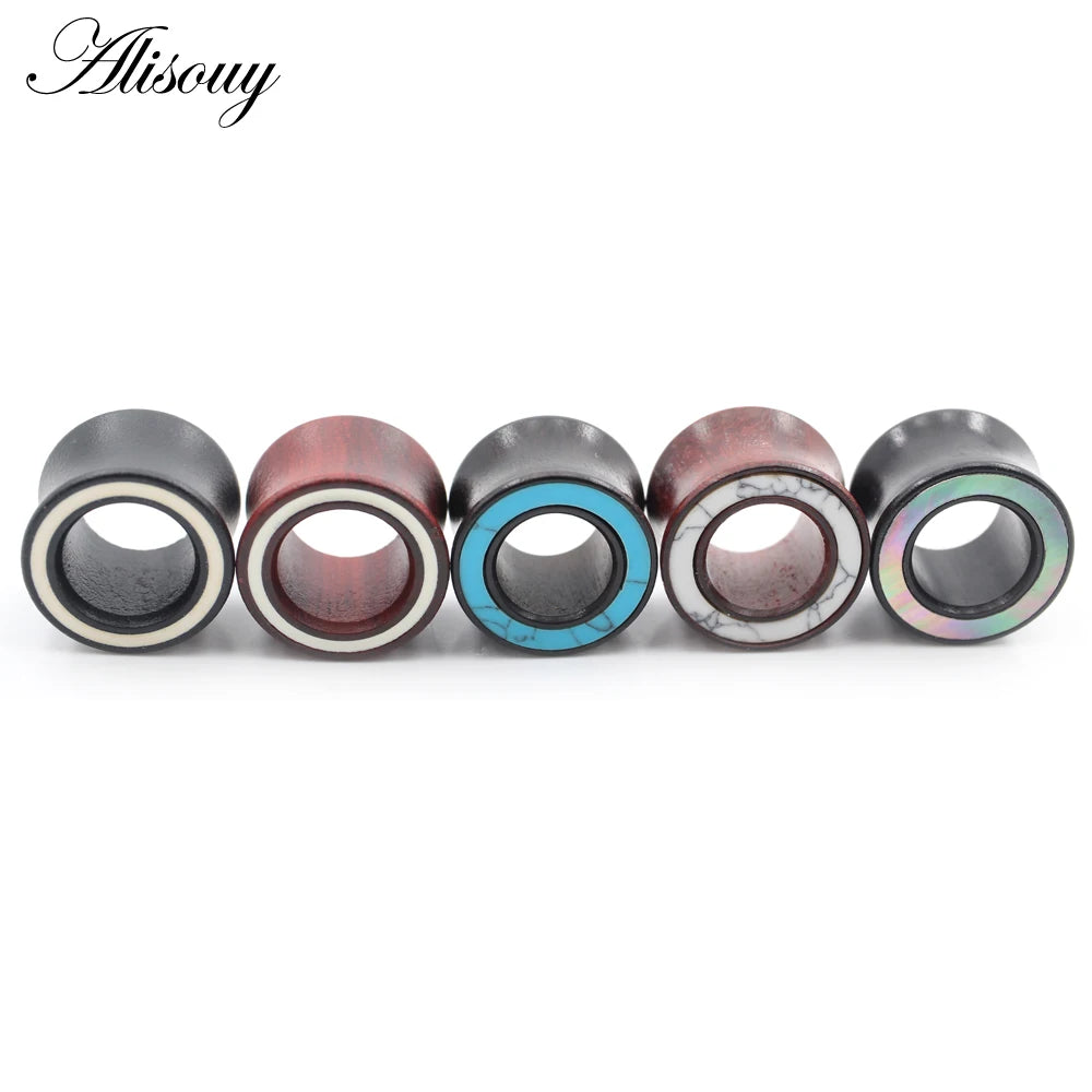 A row of six handmade wood ear tunnels featuring various natural wood tones and blue stone inlays.