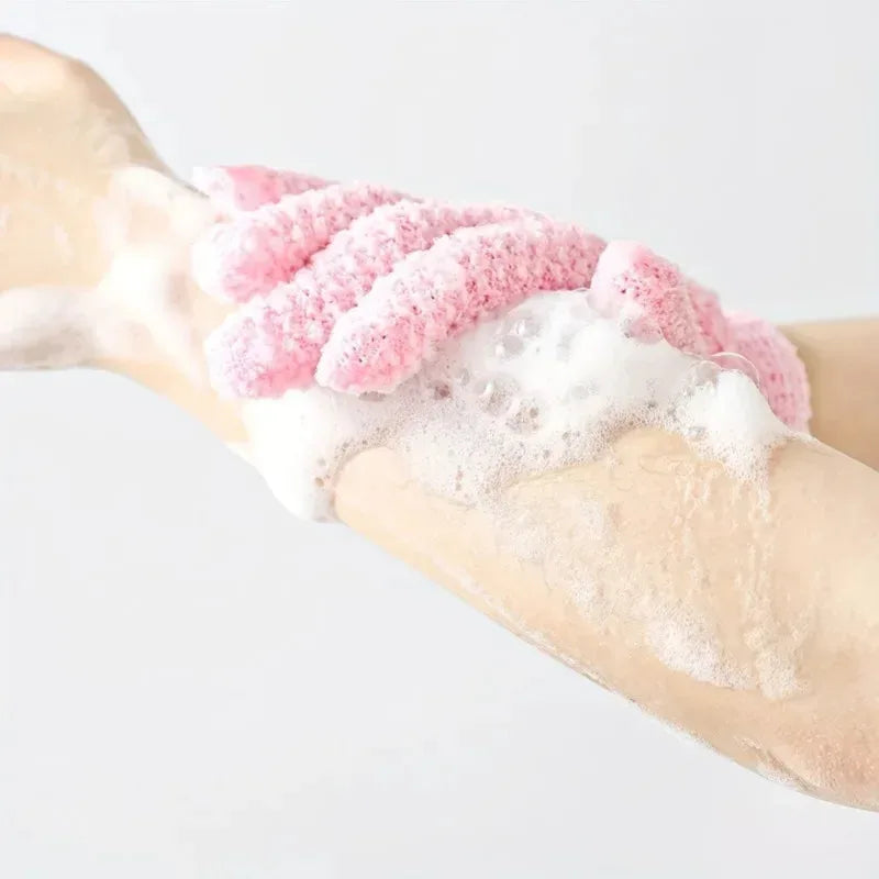 Pink exfoliating shower gloves being used for body massage and cleansing