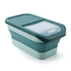 A teal collapsible airtight pet food storage container with a clear plastic lid.