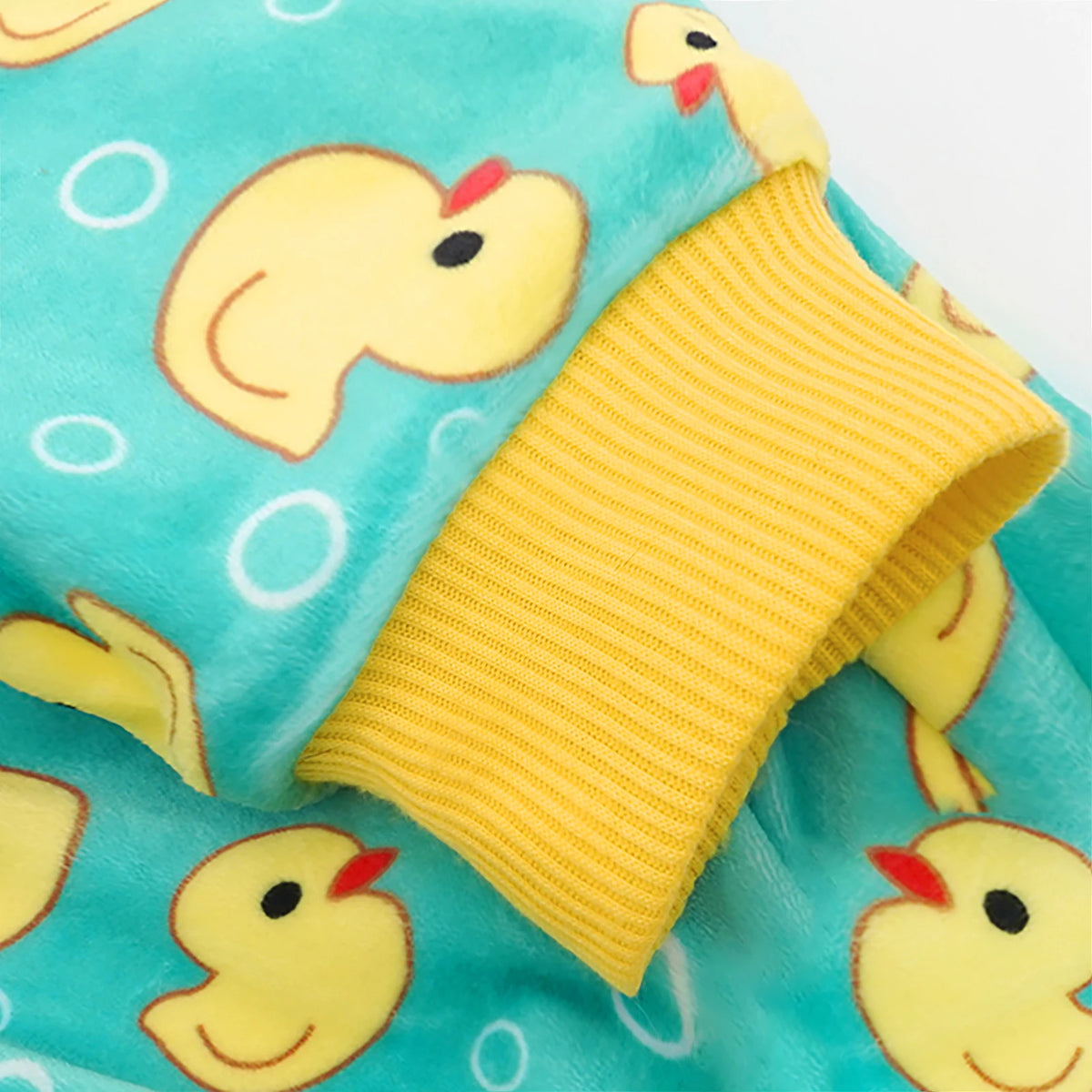 Yellow duck dog pajamas for small dogs featuring a bright turquoise fabric with yellow duck designs