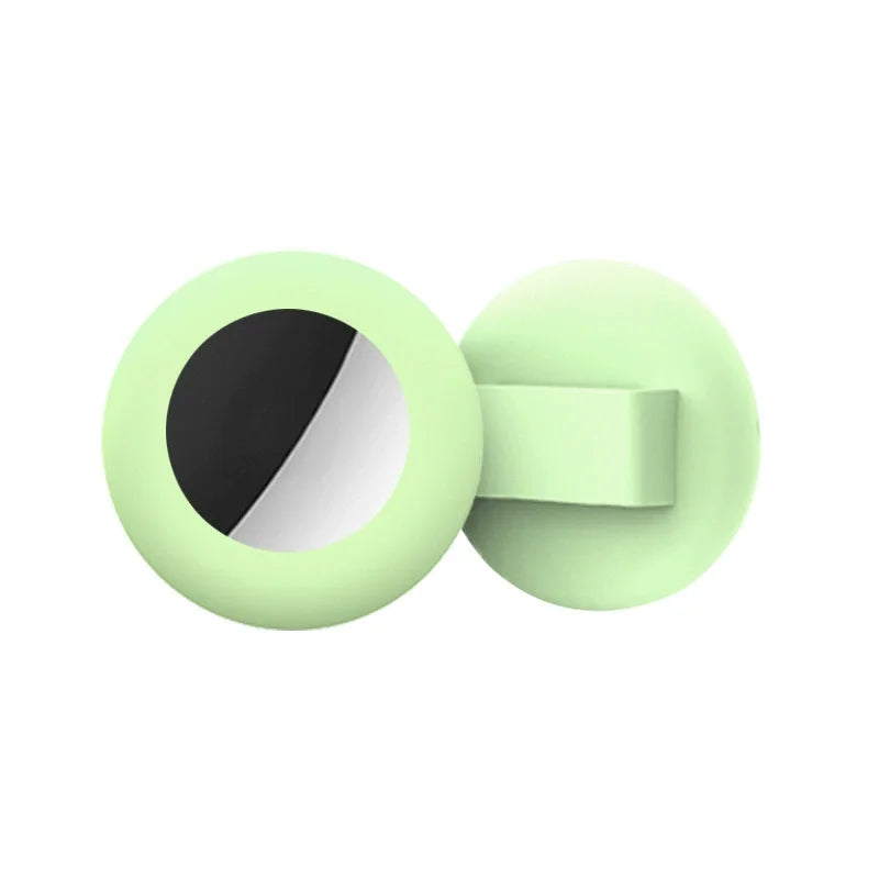 A light green silicone collar holder with a circular opening and a flat side piece.
