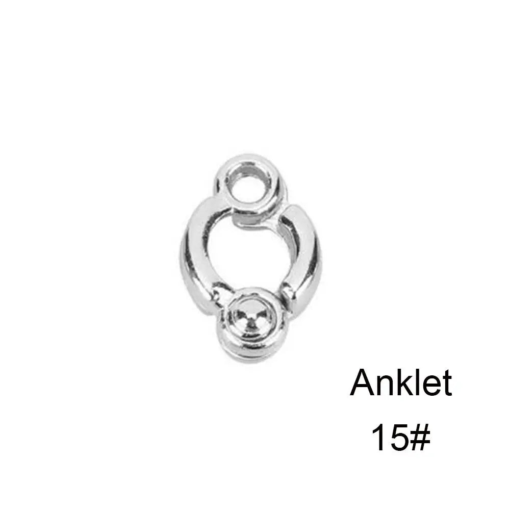 Silver ankle bracelet with a loop and a small charm.