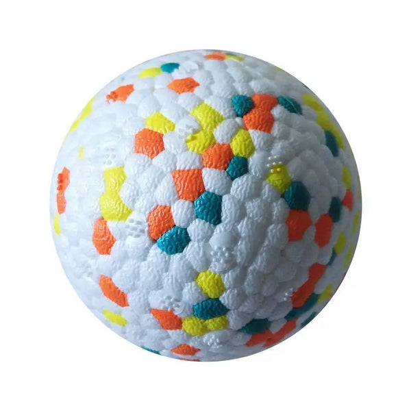 A white, textured rubber ball with colorful, irregularly shaped segments in orange, yellow, and blue.